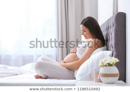 Сток-фото: Young Happy Pregnant Woman Sitting On The Window In Her Home