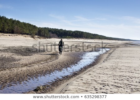 Stock fotó: Motion Blur Silhouette Of Male Biker By Sea In Sunset