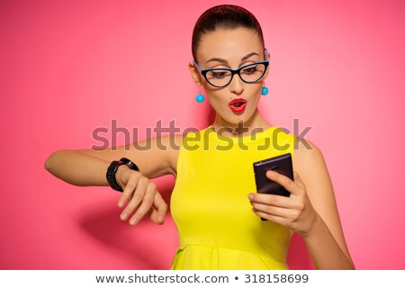 Stockfoto: Portrait Of A Pretty Smiling Woman Using Smart Watch