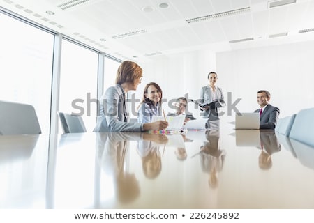 商業照片: Smiling Businesspeople In Conference Room