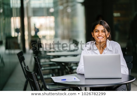 Stock photo: Portrait Of Young Seated Businesswoman Wearing A White Shirt