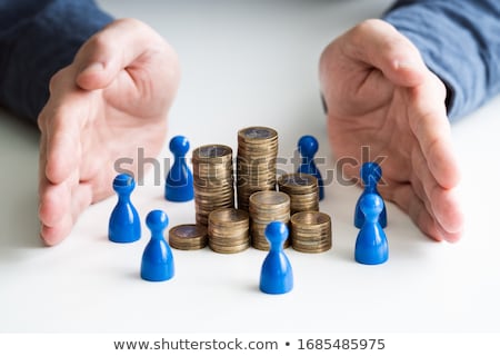 Stock fotó: Protecting Blue Human Figures Surrounding Stacked Coins