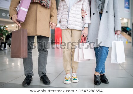 Stock fotó: Lower Part Of Casual Family Of Three Holding Paperbags With Purchases