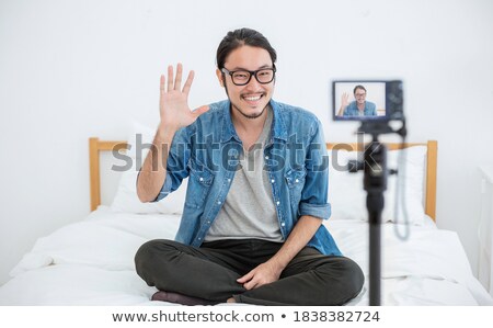 Stok fotoğraf: Young Boy Trainers On Bed