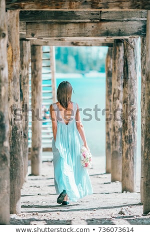 Stock photo: Beautiful Young Woman Under Wooden Pier On Beach