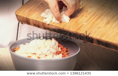 ストックフォト: Pours Crushed Onions And Carrots