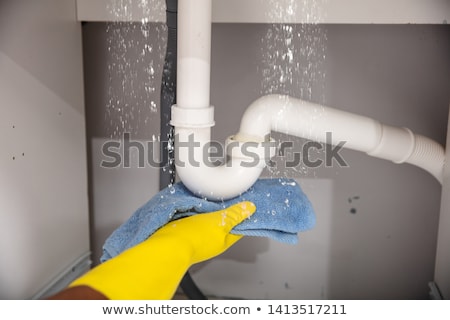 Zdjęcia stock: Woman Using Towel Under Leaking Sink Pipe