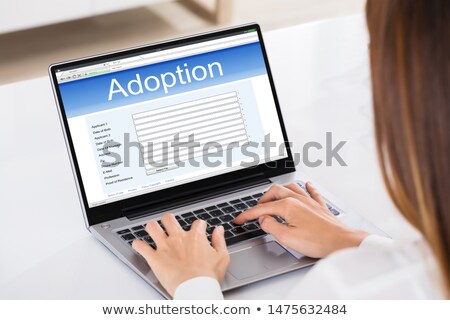 Foto d'archivio: Woman Filling Adoption Paternity Registry In Laptop