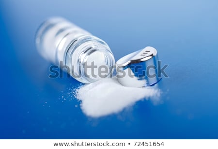 [[stock_photo]]: Salt In A Salt Shaker On Blue Background