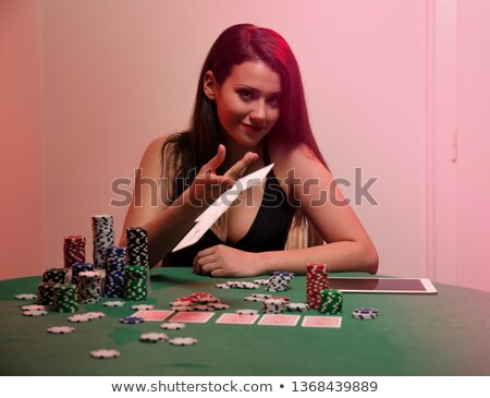 Сток-фото: Woman Sitting In A Casino At Table While Stacking Chips And Placing Cards