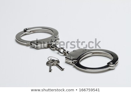 Foto stock: Handcuffs Against White Background