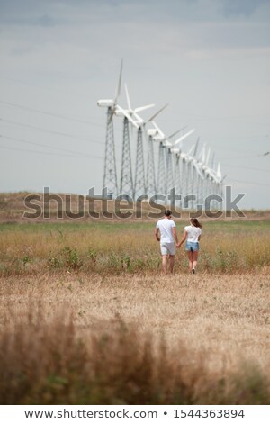 ストックフォト: Powerful Couple In Front Of Windmill