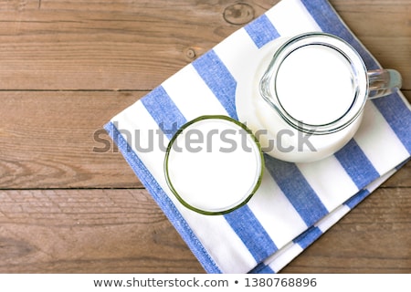 Foto stock: Glass Of Fresh Cows Milk On Blue Tablecloth