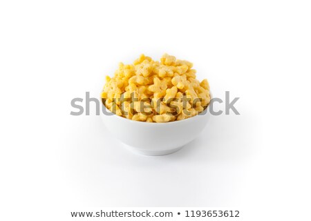 Stockfoto: Yellow Star Corn Flakes In White Bowl Isolated Top View