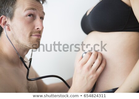 Stock photo: Father Is Listening Baby In Mothers Tummy In Front Of White Background