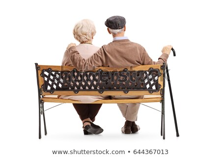 Stockfoto: Rear View Of Senior Couple Sitting Together On The Bench And Man Taking Care Of The Womanin The Park