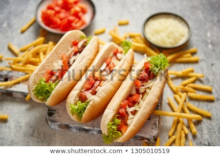 Foto stock: Assortment Of Three Tasety Hot Dogs Placed On Wooden Cutting Board