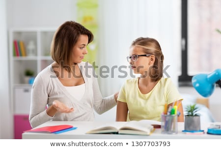 Zdjęcia stock: Upset Mother Talking To Daughter Doing Homework