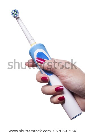 Сток-фото: Hand Holds Electric Toothbrush Against White