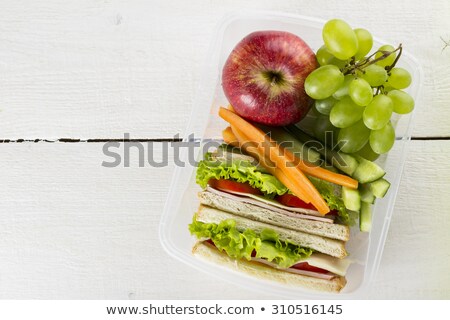 Stock photo: Green School Lunch Box With Sandwich Apple Grape Carrot And B