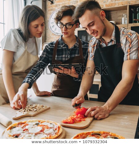 Сток-фото: Happy Friends With Chef And Tablet Pc In Kitchen