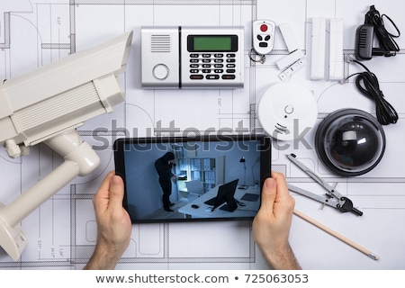 Zdjęcia stock: Architecture Looking At Cctv Footage On Digital Tablet