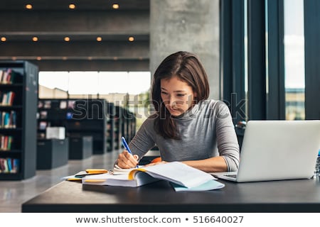 Stock photo: University Student Reading Textbook In Library