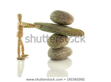 Zdjęcia stock: Wooden Puppet Holding Rocks In Perfect Balance