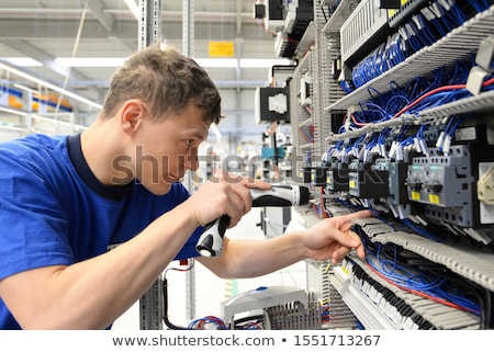 [[stock_photo]]: Engineer And Apprentice Working On Machine In Factory