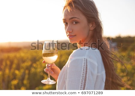 Сток-фото: Beautiful Young Brunette Woman Holding A Glass Of White Wine