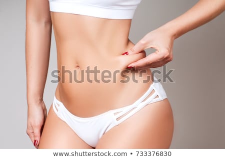 Stock photo: Female Pinching Fat On Waist