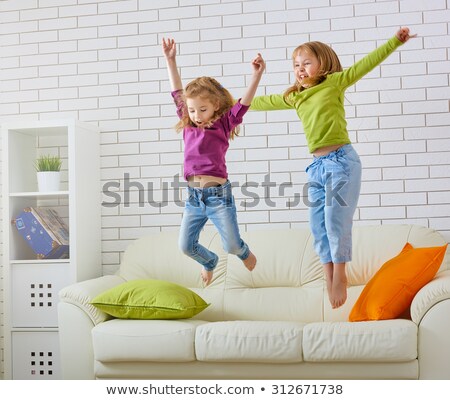 Stock photo: Two Girls Jumping On Bed