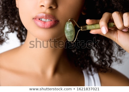 Stock photo: Young Woman Using Jade Roller