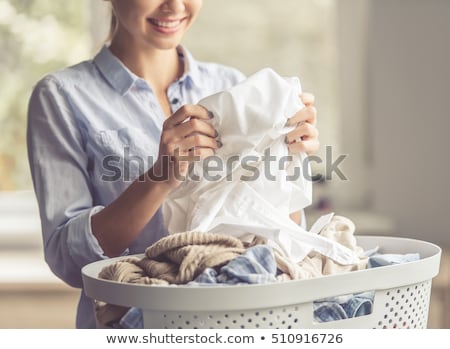 [[stock_photo]]: Smelling Washed Clothes Or Laundry