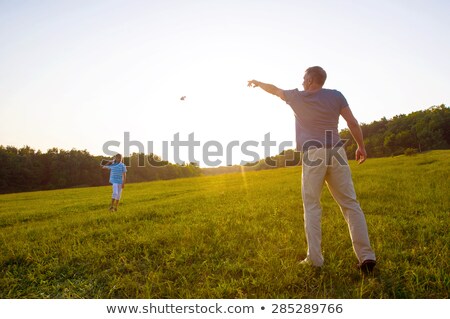 Stockfoto: Boy Launching Toy Airplane In Summer Forest