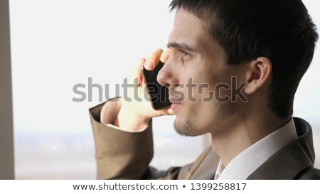 Young Businessman Talking On Mobile Phone Against City Background Сток-фото © Pressmaster