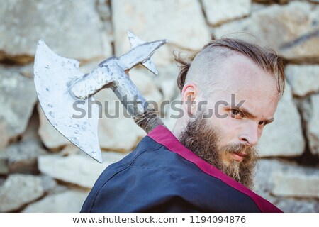 Stockfoto: Medieval Knight With A Sword Against Stone Wall