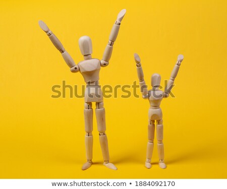 Сток-фото: Wooden Figurine Standing With Hand Raised