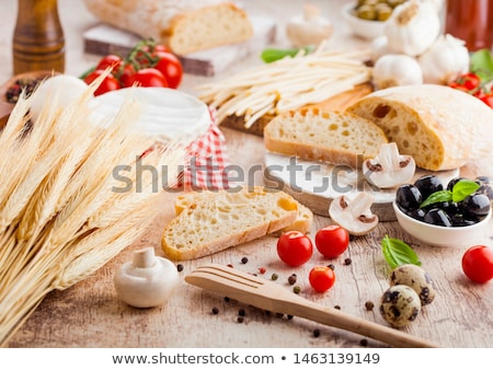 Foto stock: Homemade Wheat Bread With Quail Eggs And Raw Wheat And Fresh Tomatoes On Wooden Background Classic