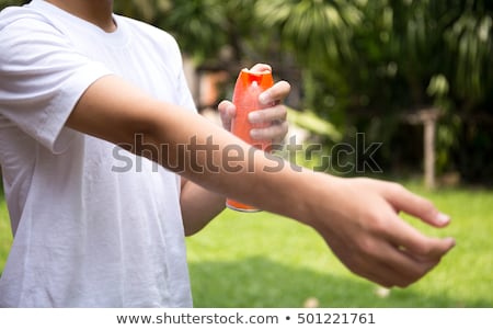 ストックフォト: Boy Spraying Insect Repellents On Skin