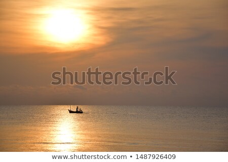 Stok fotoğraf: Small Fishing Boat At Sunset