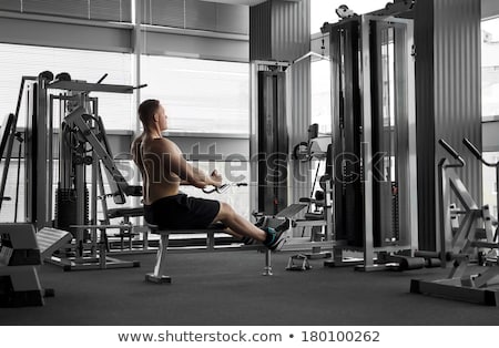 Foto stock: Athletic Bodybuilder Execute Exercise In Sport Gym Hall
