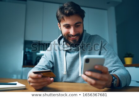 Stockfoto: Man Hand Sitting And Using Smartphone In The Evening