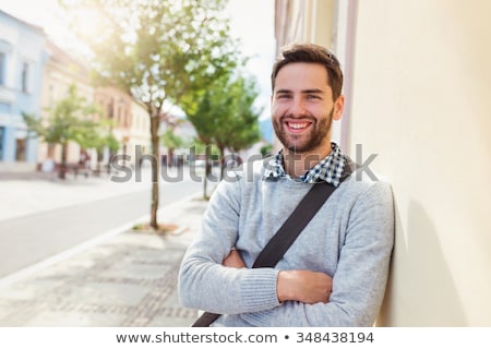 Zdjęcia stock: Young Casual Man Is Smiling And Walking