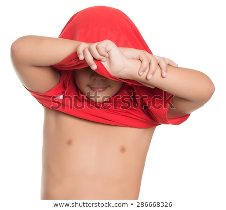 Stock fotó: Boy Taking Off T Shirt