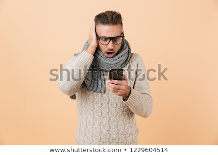 Zdjęcia stock: Portrait Of A Shocked Man Dressed In Sweater And Scarf