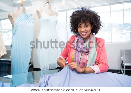 Stok fotoğraf: Front View Of Young Mixed Race Female Fashion Designer Working With Sewing Machine
