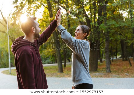 Zdjęcia stock: Photo Of Beautiful Delighted Couple Giving Fives While Working Out