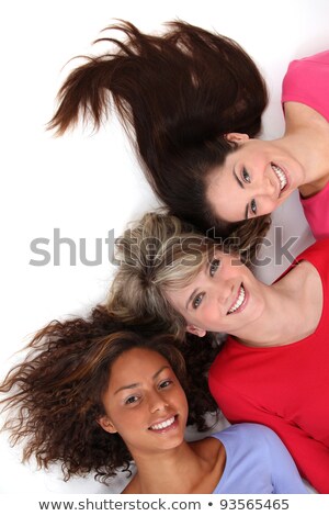 Foto stock: Three Female Friends Laying Next To Each Other