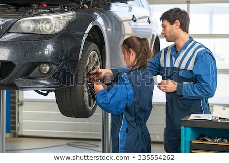 Stock photo: Mechanic Teaching An Intern In A Garage